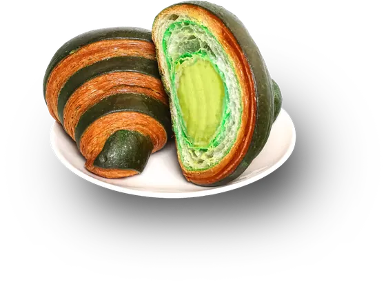 A green-striped croissant cut open to show avocado custard
