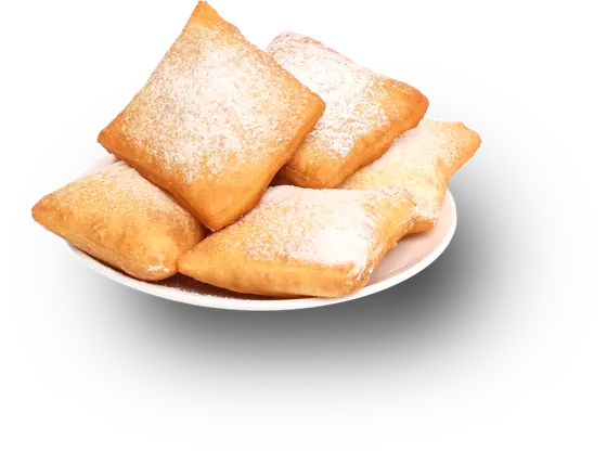 A plate of beignets dusted with powdered sugar